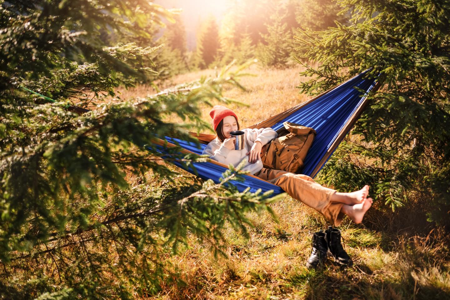 Relaxing in a hammock outdoors.